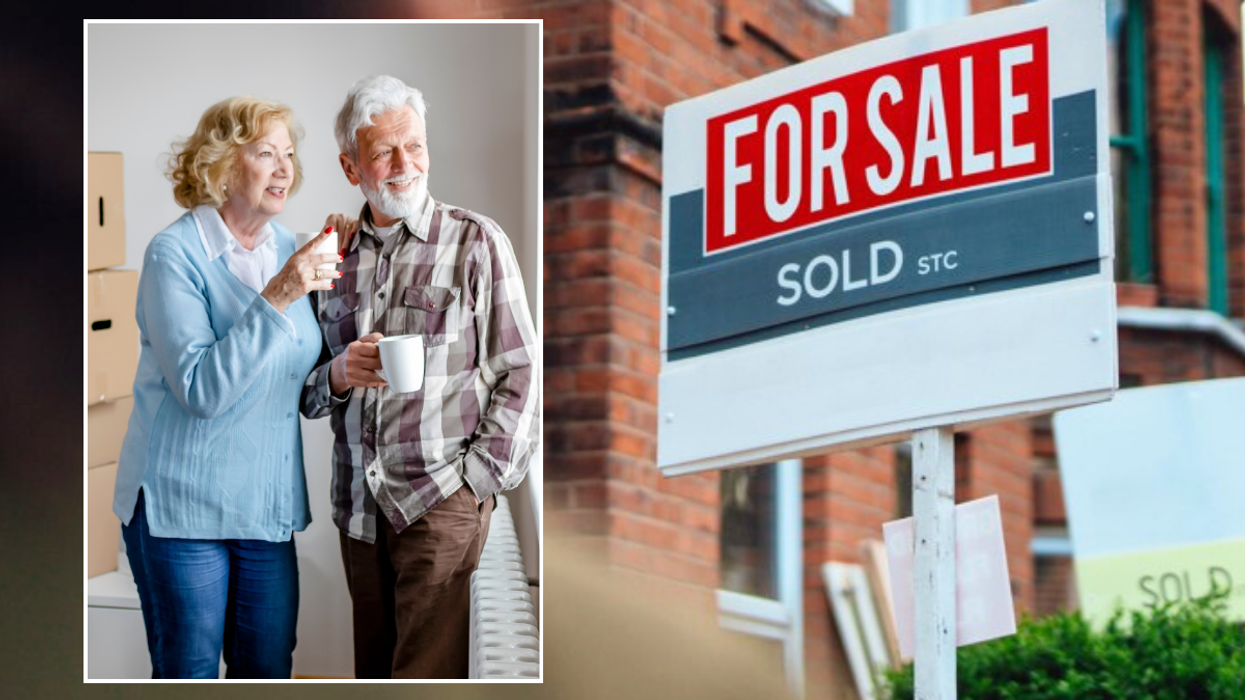 Couple moving house / for sale sign