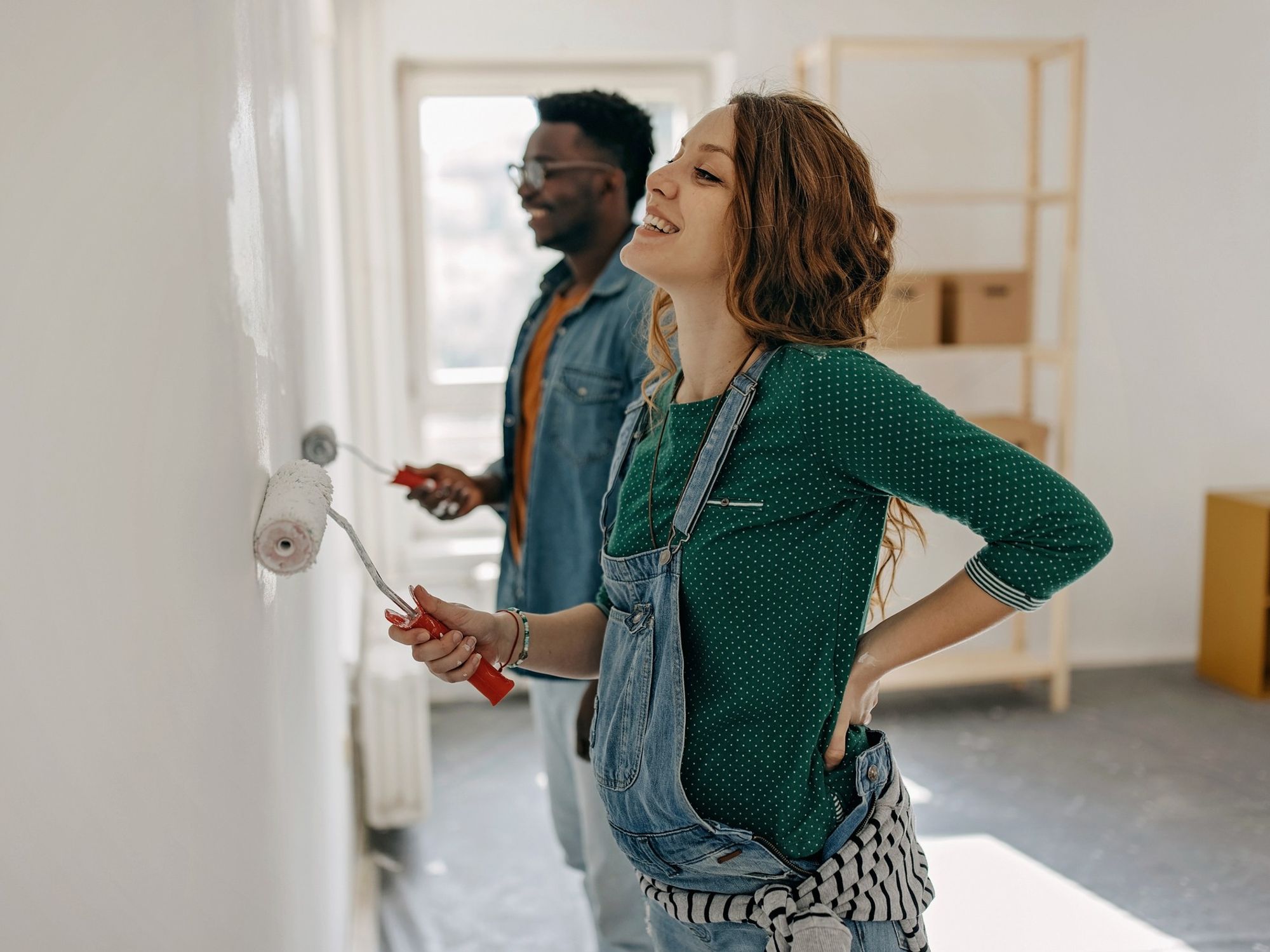 Couple painting their walls grey