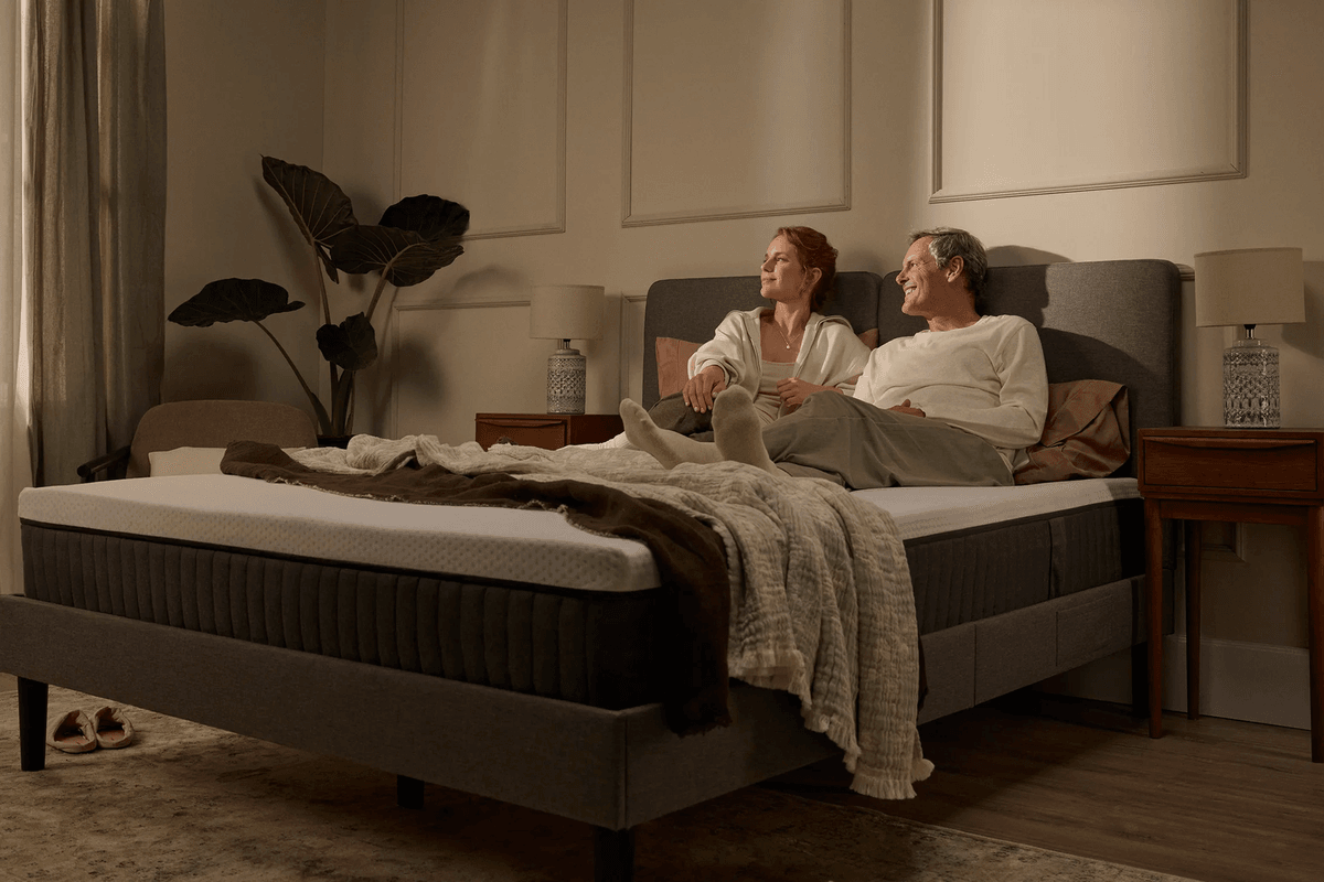 Couple sitting on Emma mattress