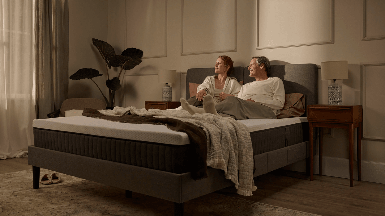 Couple sitting on Emma mattress