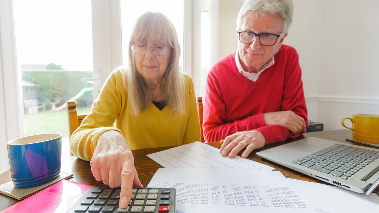 Couple use calculator while they look at finances