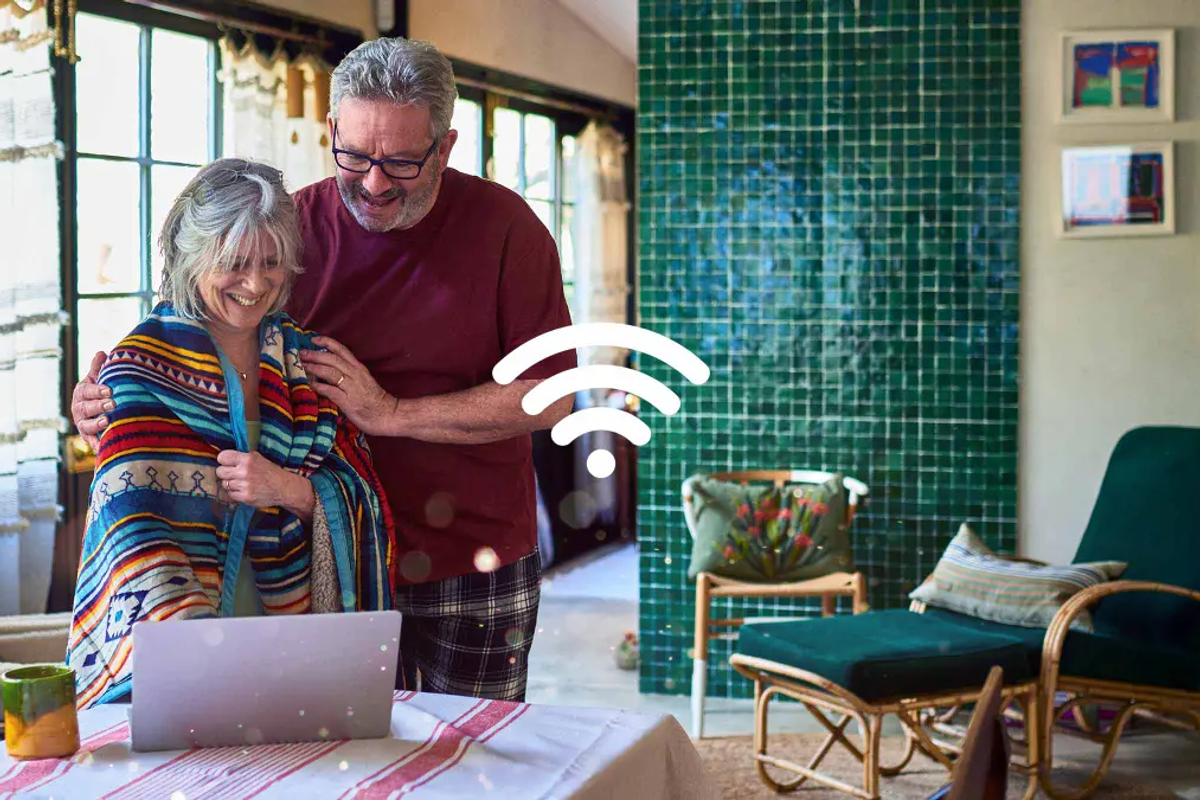 Couple using Wi-Fi on their laptop inside their home