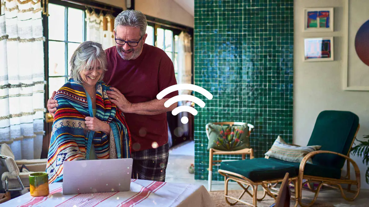 Couple using Wi-Fi on their laptop inside their home