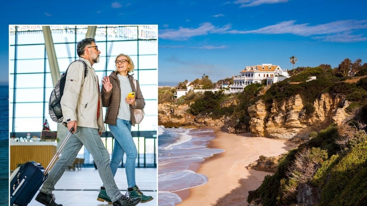 Couple wheeling suitcase, going on holiday / Spain