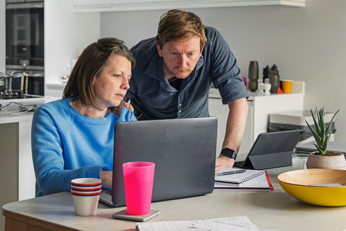 Couple worried at laptop