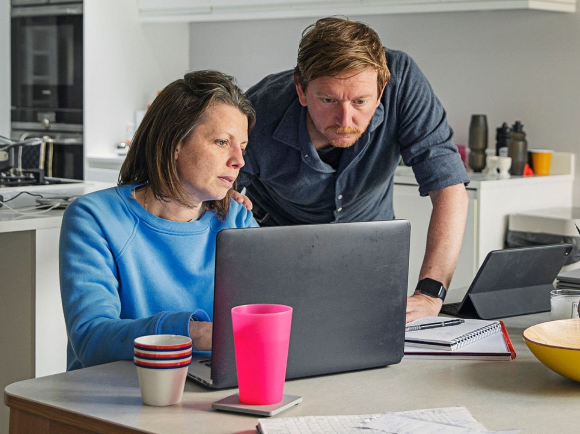Couple worried at laptop