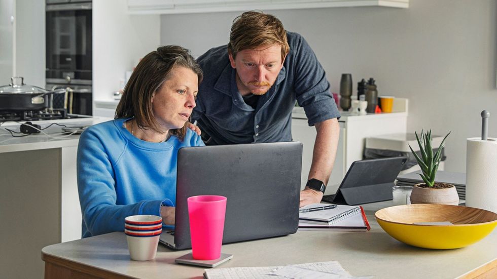Couple worried at laptop