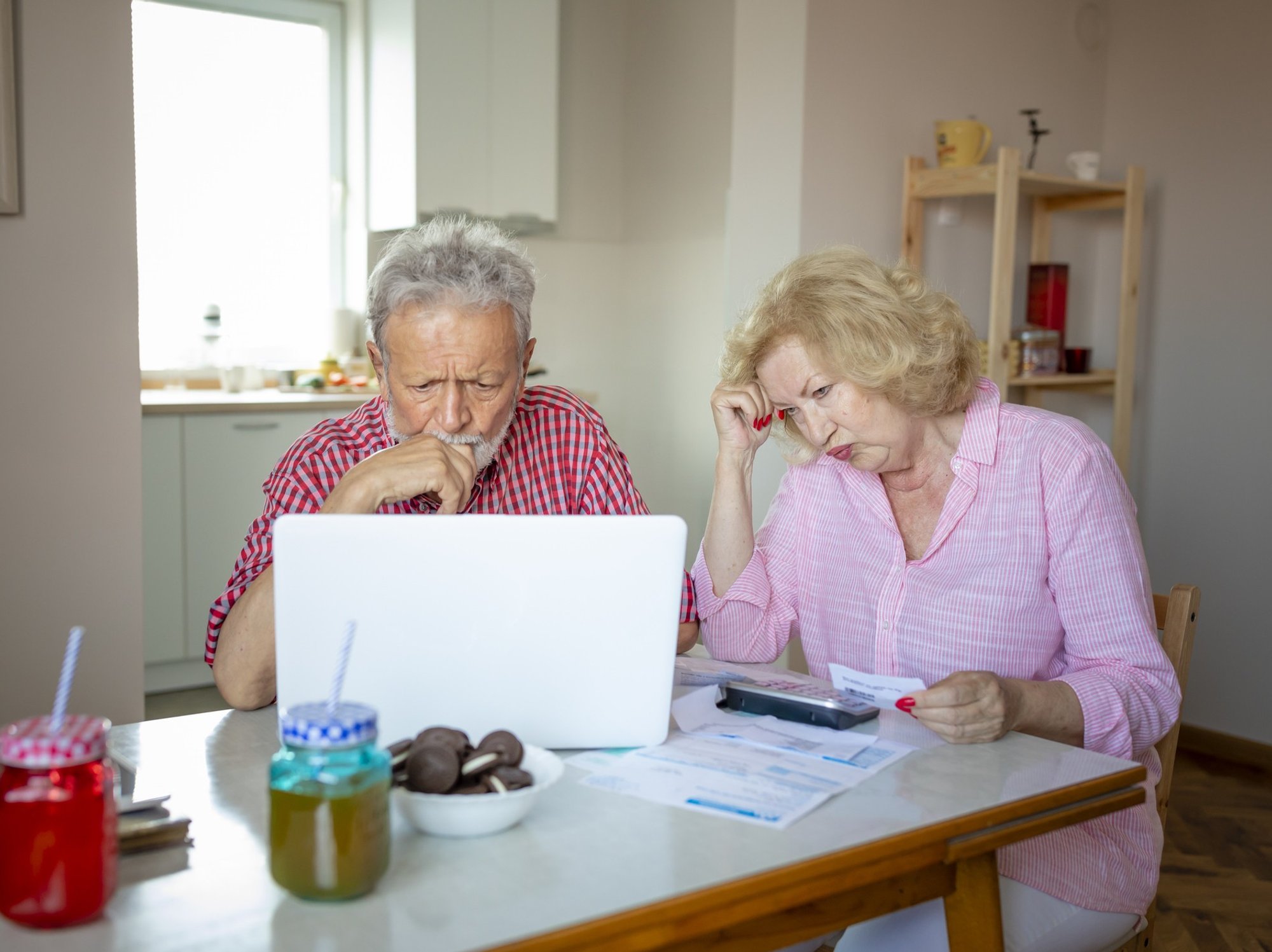 Couple worried looking at bills