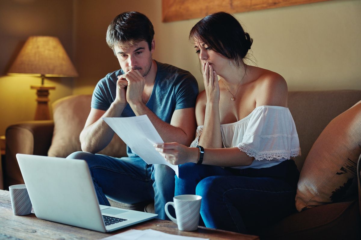 Couple worried looking at document