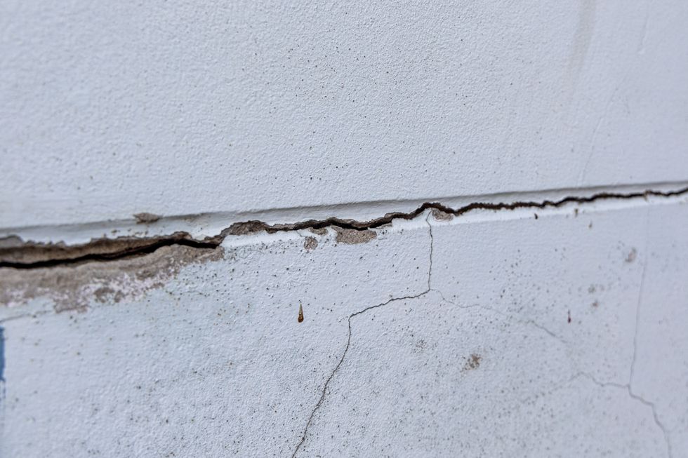 Crack on the outside of a white wall