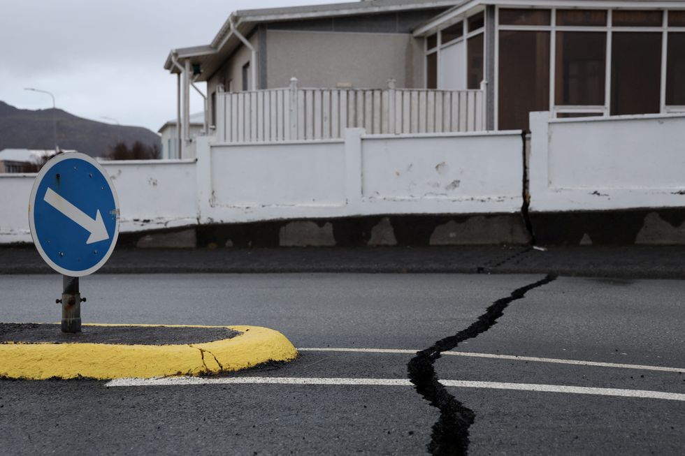 Cracks emerge on a road due to volcanic activity near a police station
