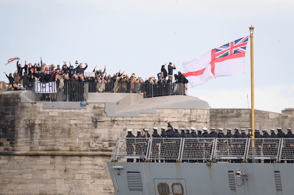 Crew members wave goodbye to family and friends as HMS Dragon sets sail from Portsmouth Harbour on March 10, 2026 in Portsmouth, England.