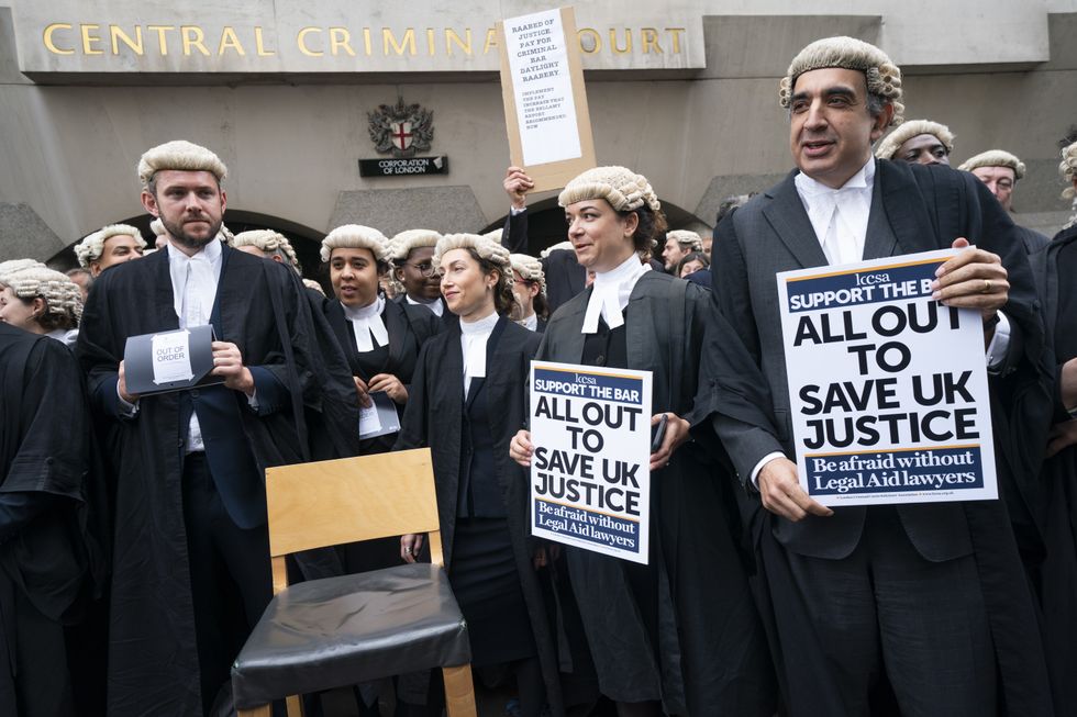 Criminal barristers from the Criminal Bar Association (CBA), which represents barristers in England and Wales, outside the Old Bailey, central London, on the first of several days of court walkouts by CBA members in a row over legal aid funding. Picture date: Monday June 27, 2022.