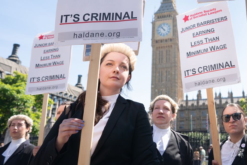 Criminal defence barristers outside the Houses of Parliament in London as they support the ongoing Criminal Bar Association (CBA) action over Government set fees for legal aid advocacy work. Picture date: Monday July 11, 2022.