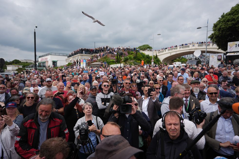Crowds listen as Leader of Reform UK Nigel Farage launches his General Election campaign in Clacton-on-Sea, Essex