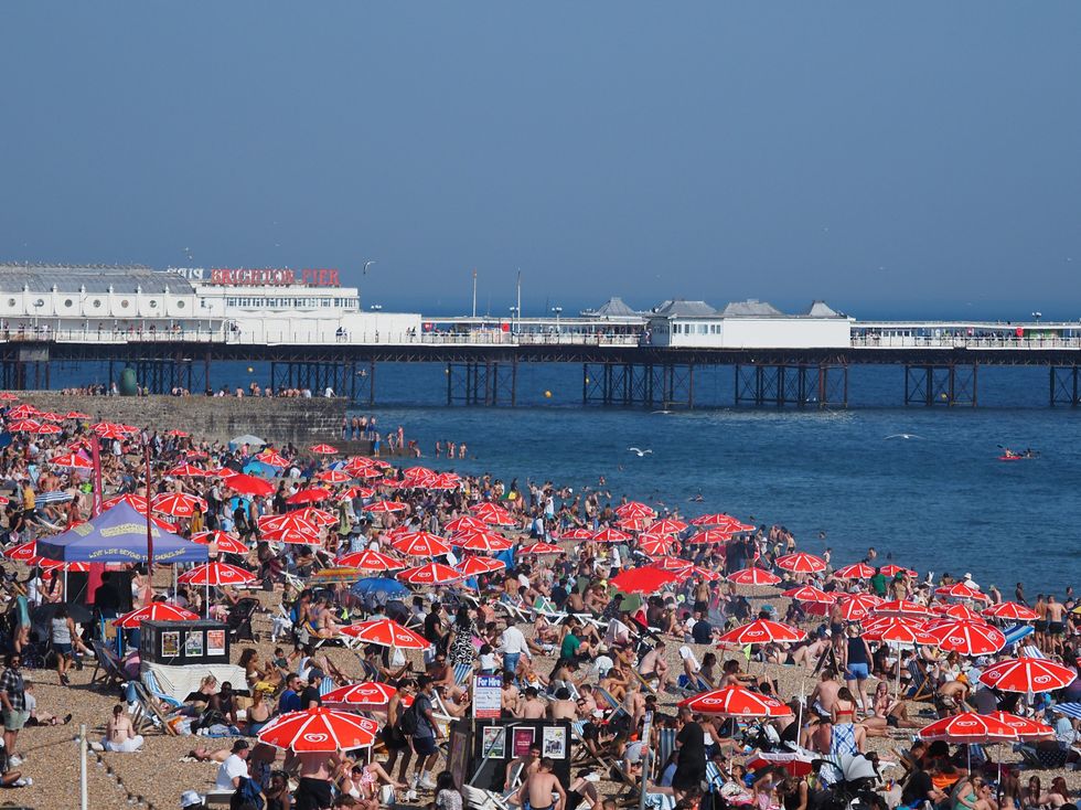 Crowds on Brighton beach in East Sussex as temperatures rise across the south east