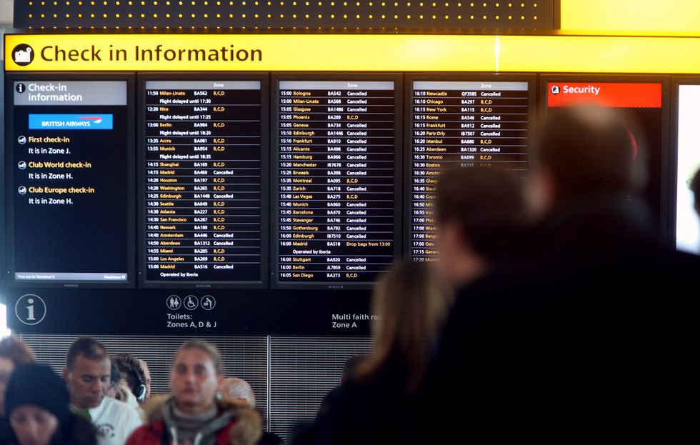 Crowds wait for details of their flights at Heathrow Terminal five