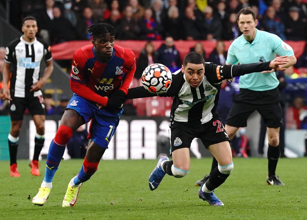 Crystal Palace's Wilfried Zaha (left) and Newcastle United's Miguel Almiron battle for the ball during the Premier League match at Selhurst Park, London. Picture date: Saturday October 23, 2021.