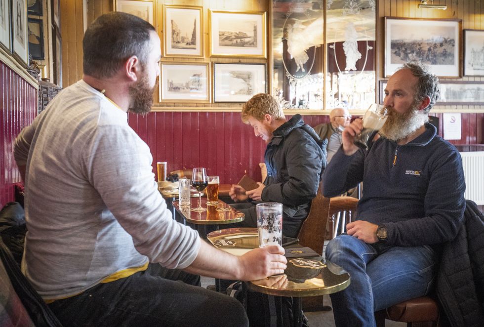 Customers in the Waverley, Edinburgh, enjoy a drink inside the bar.