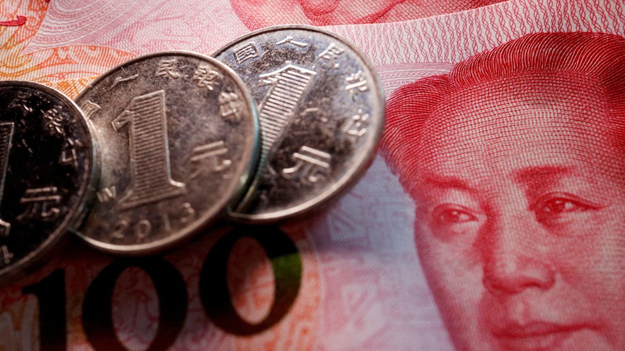Customers select tomatoes at a stall inside a morning market in Beijing, China