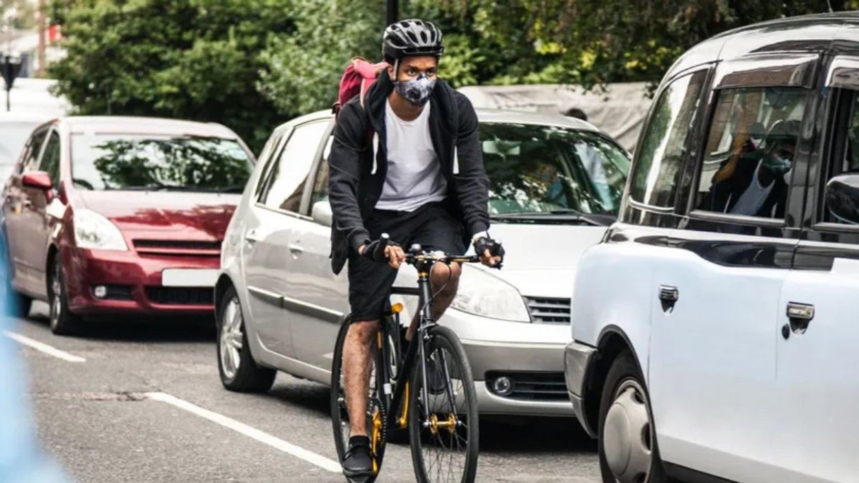Cyclist riding next to cars