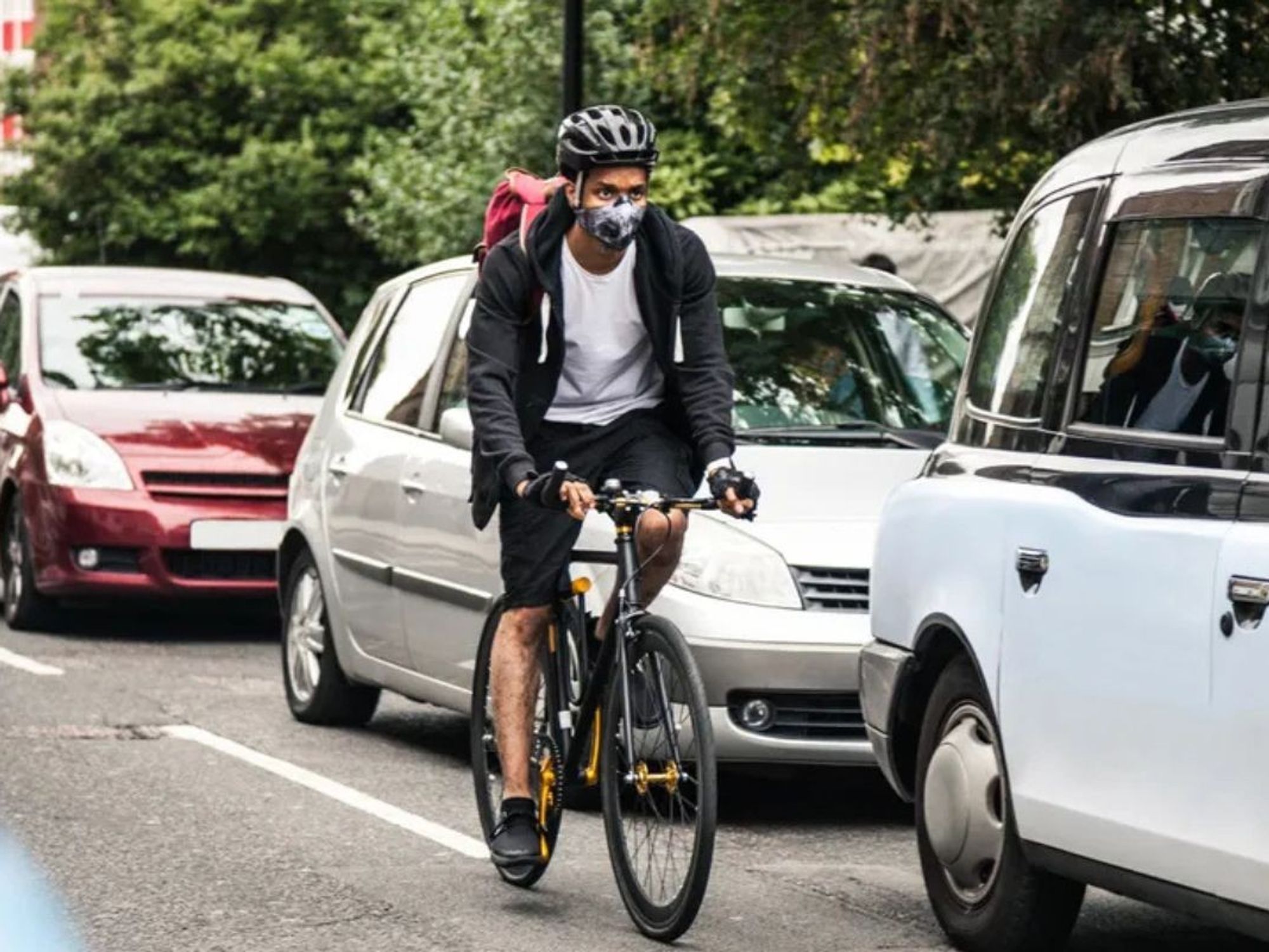 Cyclist riding next to cars