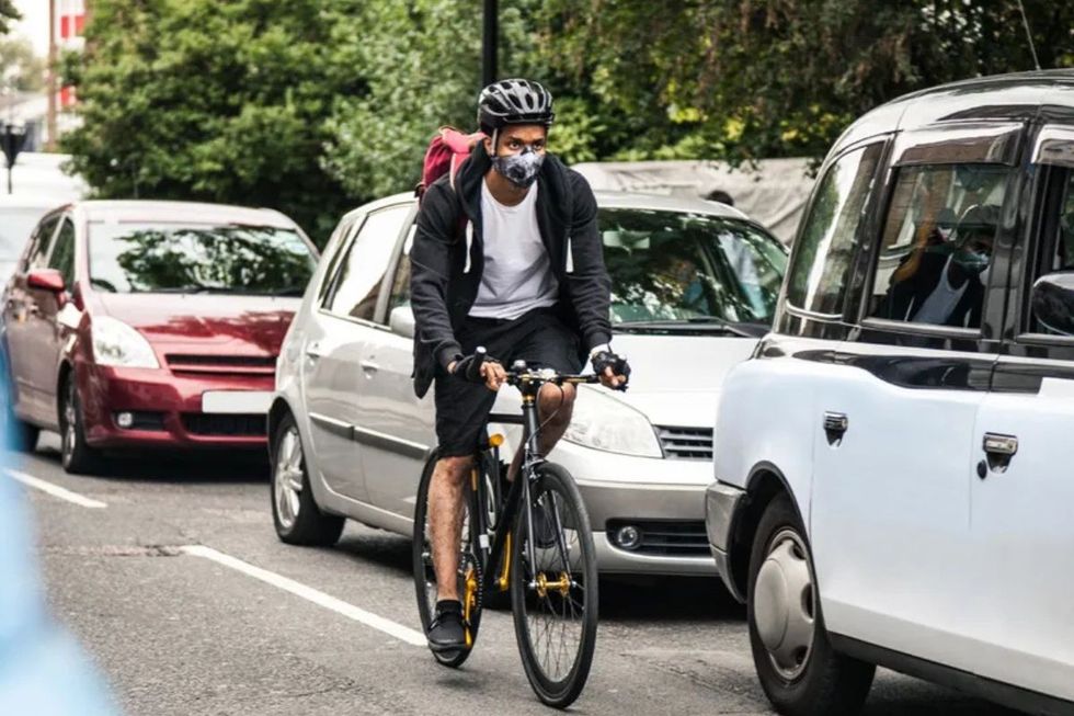 Cyclist riding next to cars