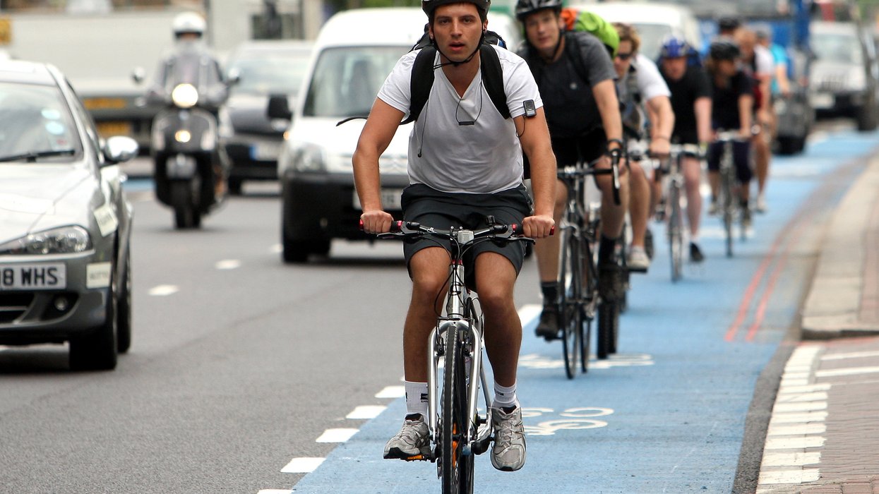 Cyclists riding on a busy road