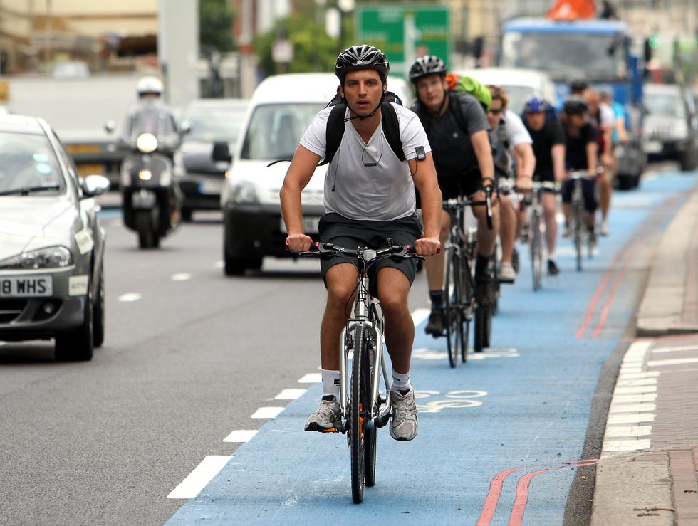 Cyclists riding on a busy road