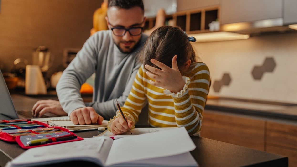 Dad and daughter do homework together
