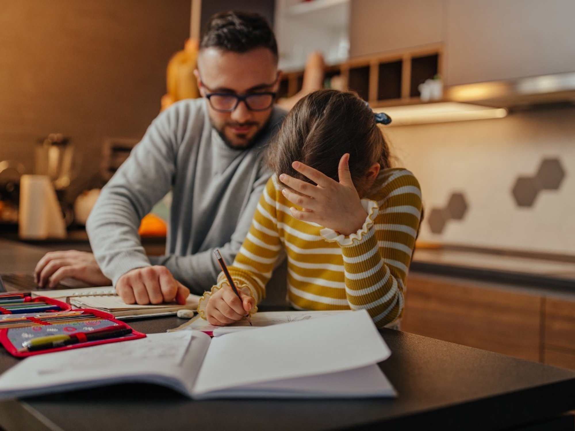Dad and daughter do homework together