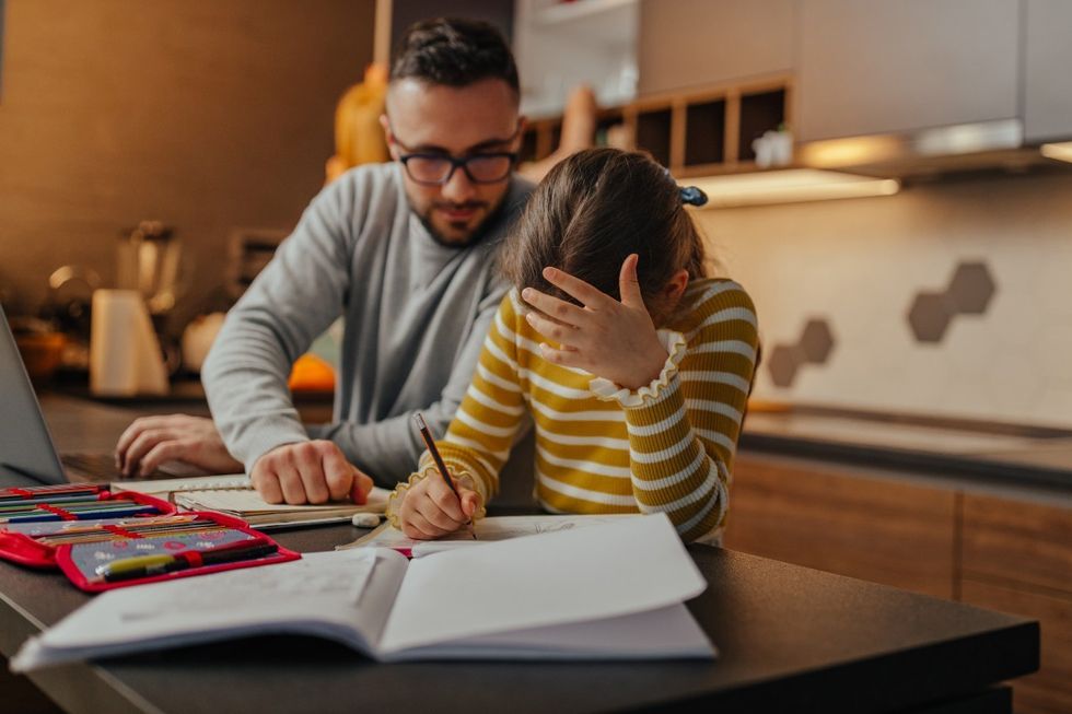 Dad and daughter do homework together