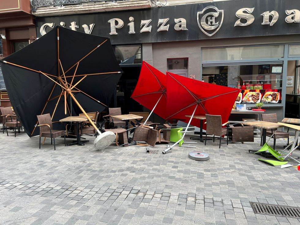 Damage is seen at the site where a van drove into a cafe terrace