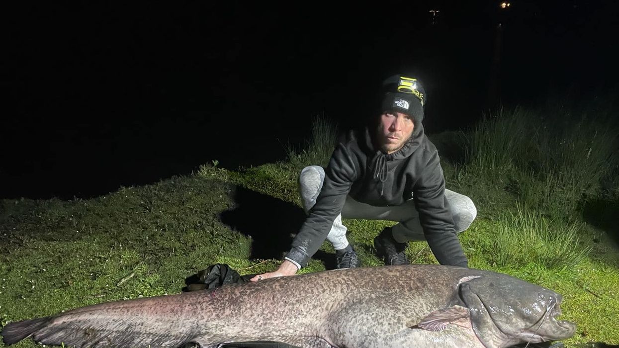 Darren Reitz, with the fish he named "Scar"