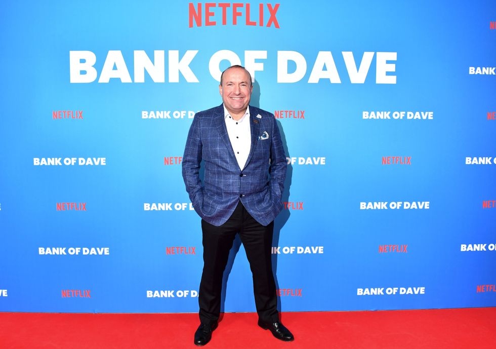 Dave Fishwick in front of standee for Bank of Dave
