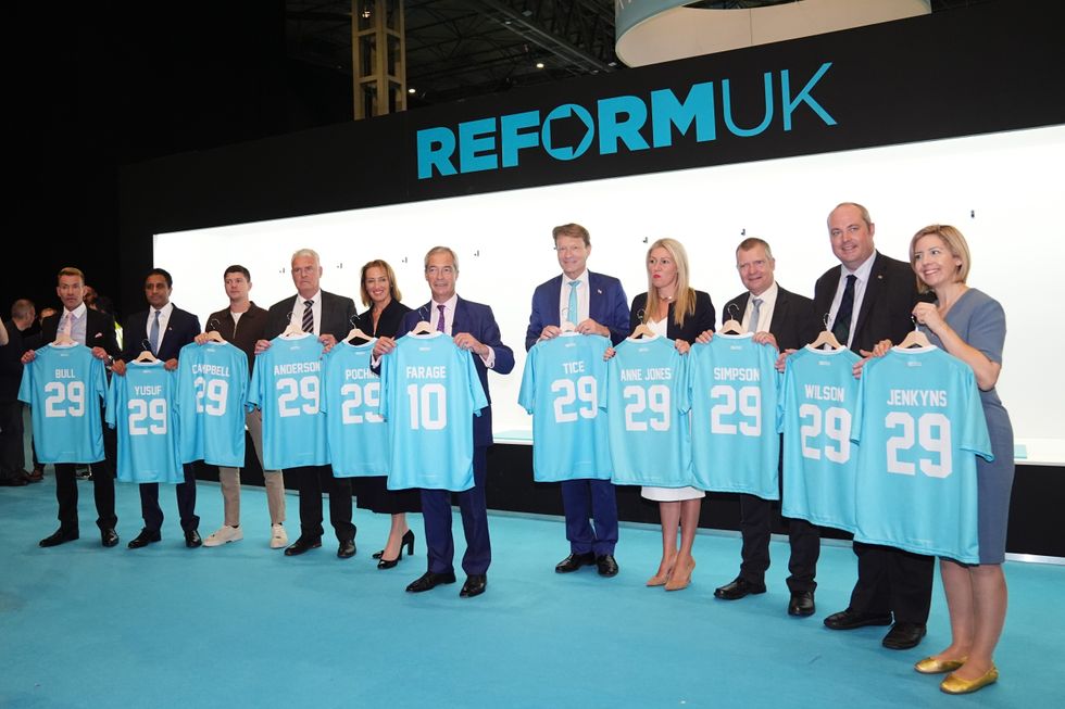 David Bull, Zia Yusuf, Luke Campbell, Lee Anderson, Sarah Pochin , Reform UK leader Nigel Farage, Richard Tice, Laura Anne Jones, Graham Simpson, Alex Wilson and Andrea Jenkyns pose with their football shirts during the party's annual conference at the National Exhibition Centre in Birmingham