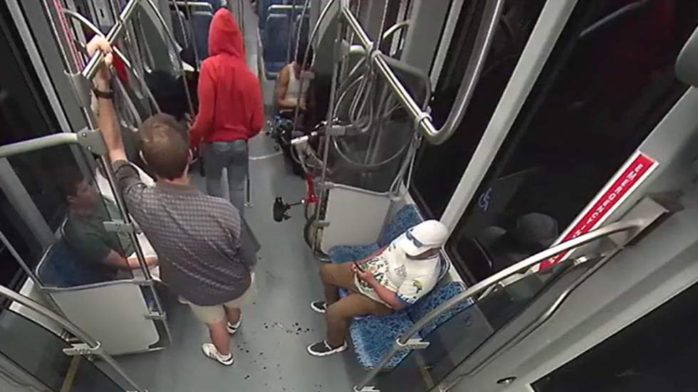 Decarlos Brown Jr walks across train