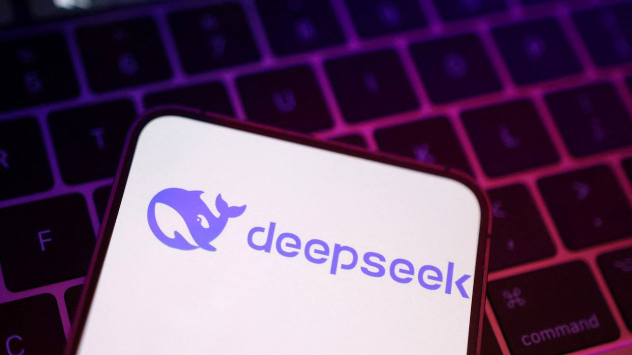 DeepSeek AI logo on an iPhone screen pictured lying on a laptop keyboard