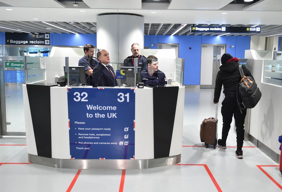 Defence Secretary Ben Wallace (2nd left) at passport control at Manchester airport meeting members of the military as they cover for striking Border Force officers. Public and Commercial Services union (PCS) members working as Border Force officers at Gatwick, Heathrow, Birmingham, Cardiff, Manchester and Glasgow airports and the port of Newhaven resumed strikes on Wednesday for four days over pay, jobs and conditions. Picture date: Thursday December 29, 2022.