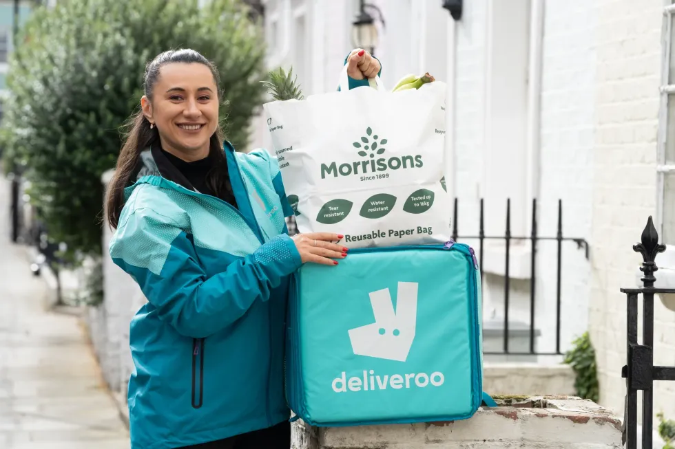 Deliveroo driver holding Morrisons bag