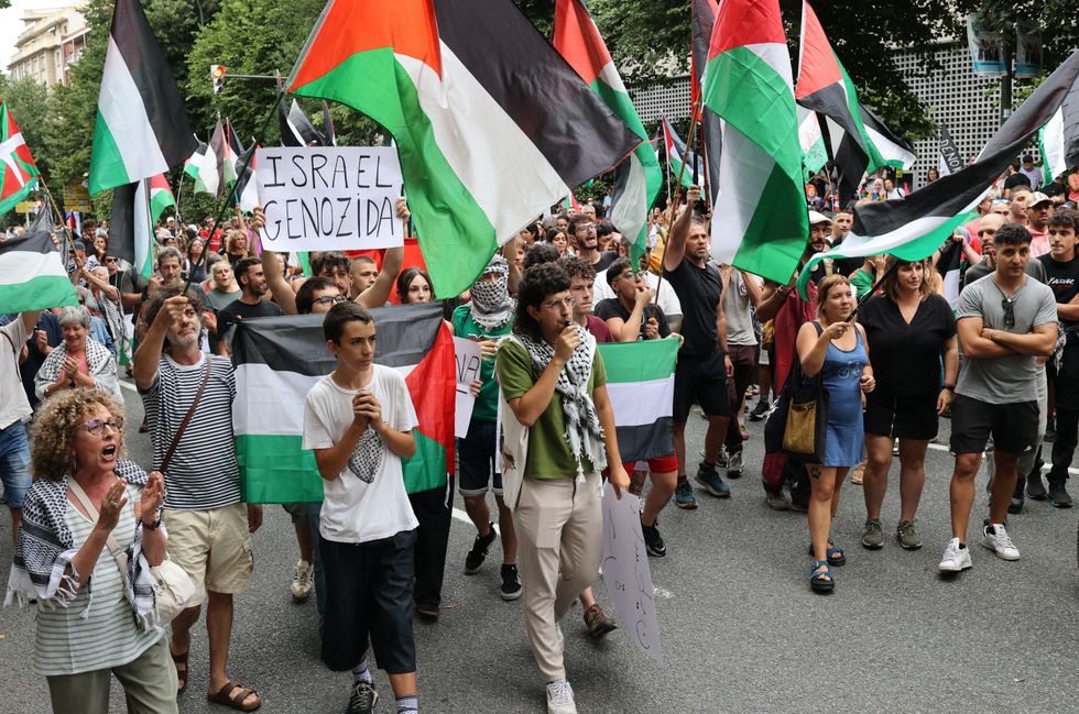 Demonstrators carrying Palestinian flags and banners blocked the road