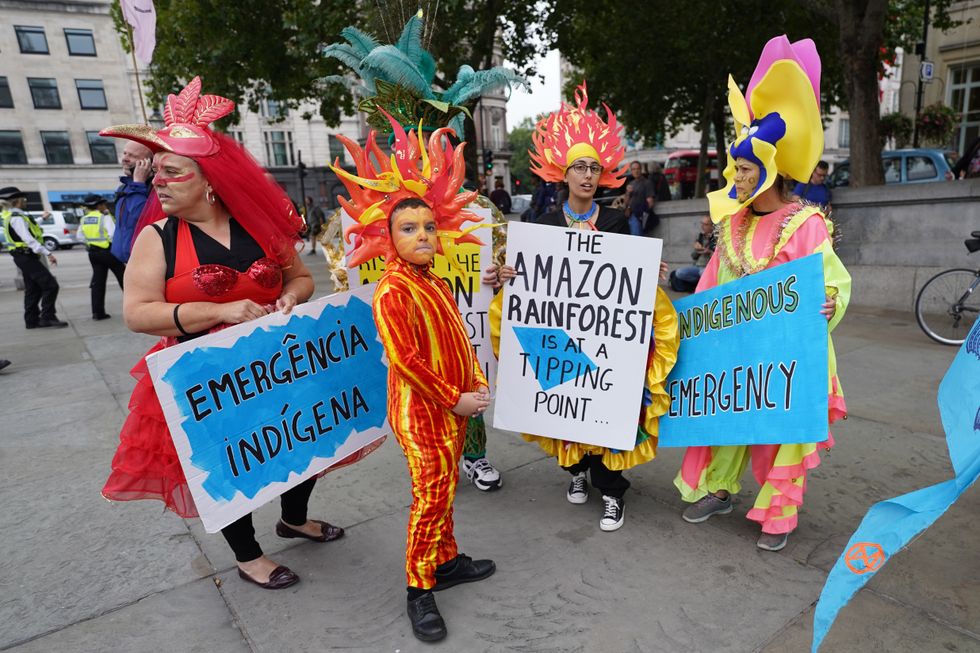 Demonstrators from Animal Rebellion and Nature Rebellion protest in Trafalgar Square in London.