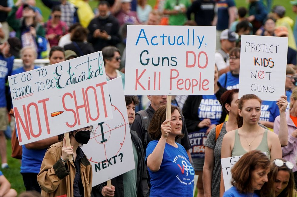Demonstrators hold placards as they take part in the 'March for Our Lives', one of a series of nationwide protests against gun violence, in Washington, DC.