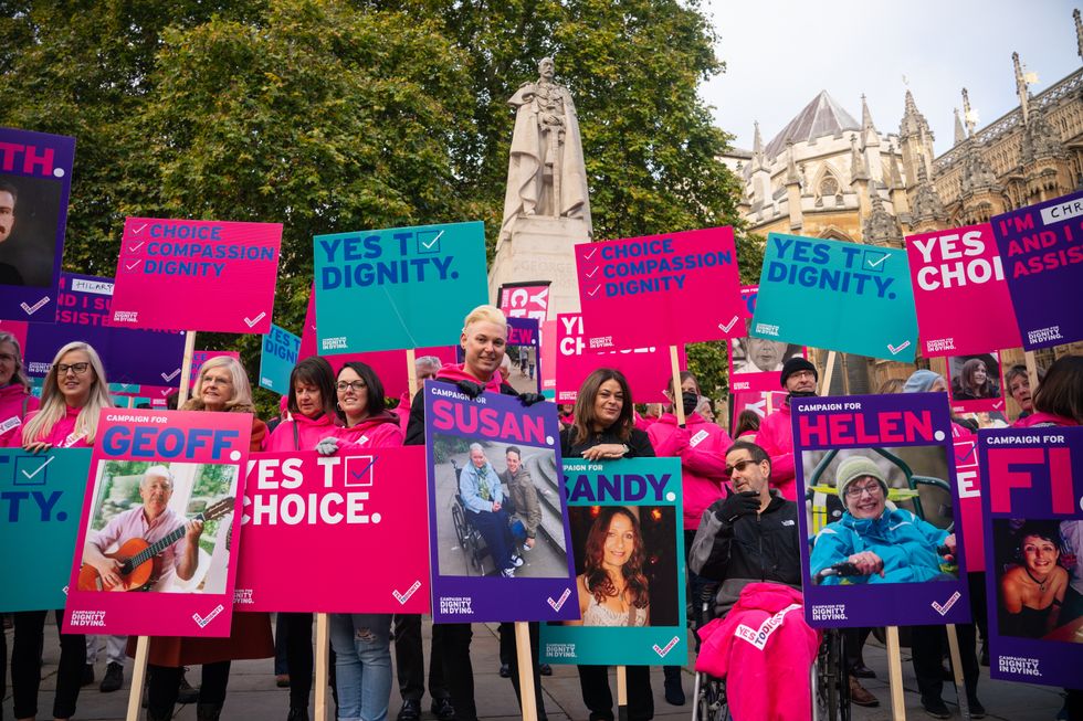 Demonstrators, including Humanists UK's members and supporters, during a protest outside the Houses of Parliament in London to call for reform as peers debate the new assisted dying legislation. Picture date: Friday October 22, 2021.