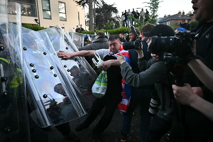 Demonstrators push against a police line near Portswood Police Station,\u200b