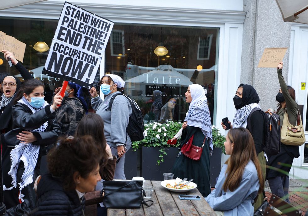 Demonstrators take their "Emergency Rally: Stand with Palestinians Under Siege in Gaza" out of Harvard University and onto the streets of Harvard Square