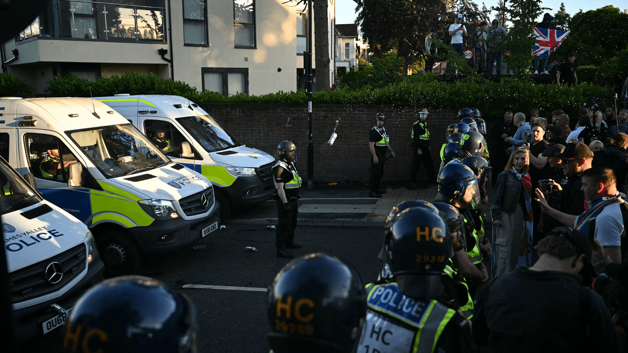 Demonstrators throw items at Police officers