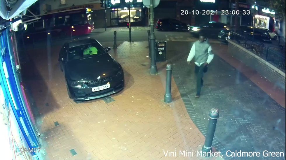 Deng Chol Majek walking to a store on Caldmore Green