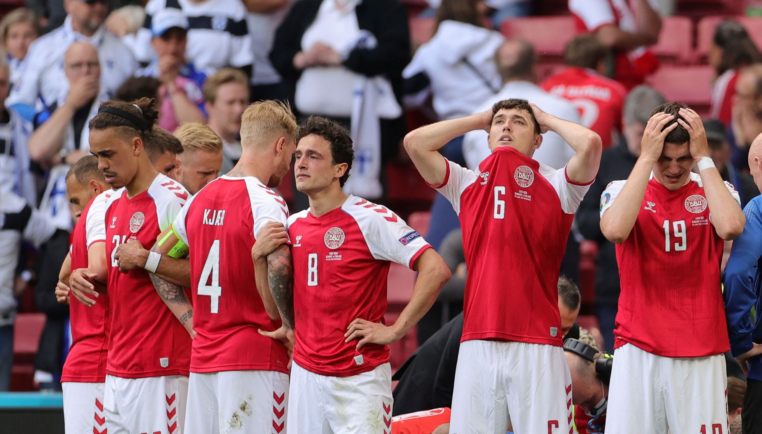 Denmark players created a shield as Christian Eriksen received medical attention on the pitch