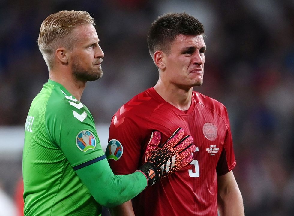 Denmark's Kasper Schmeichel and Joakim Maehle look dejected after the match Pool via REUTERS/Laurence Griffiths
